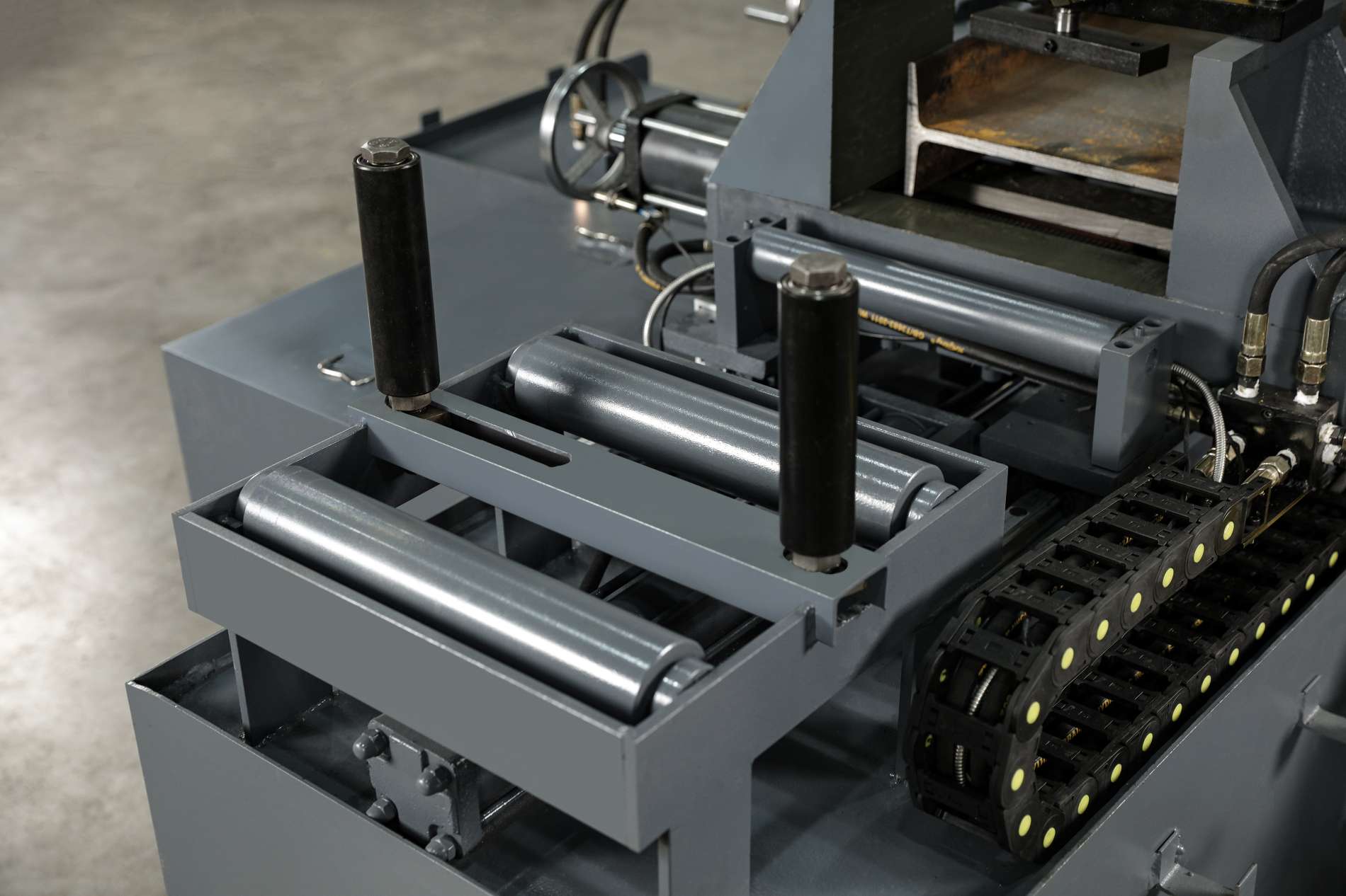 CNC horizontal miter bandsaw cutting zone showing heavy duty hydraulic clamping vise and precision guide arms by MFG