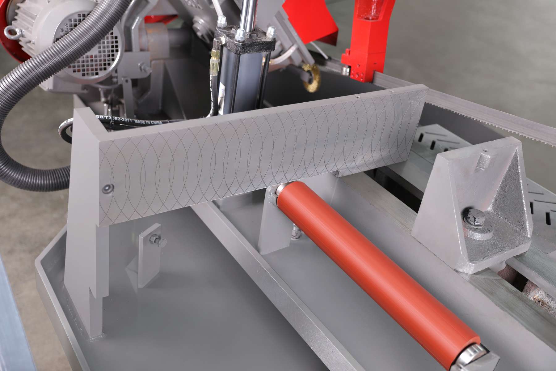 Rotary miter metal bandsaw cutting zone showing hydraulic side clamping vise and guide arms by MFG